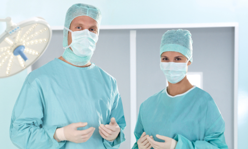 surgical team with OR-cap, OR-mask, OR-gown and sterile gloves